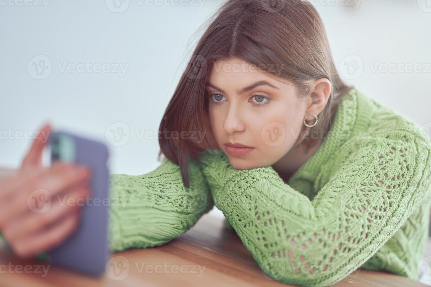 Teenage girl texting at home photo