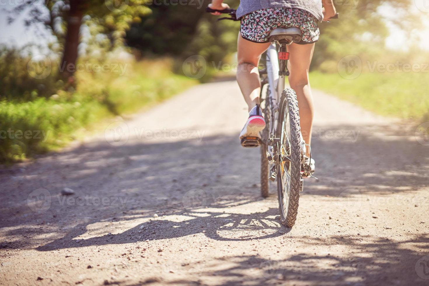 Midsection of a woman on bike photo