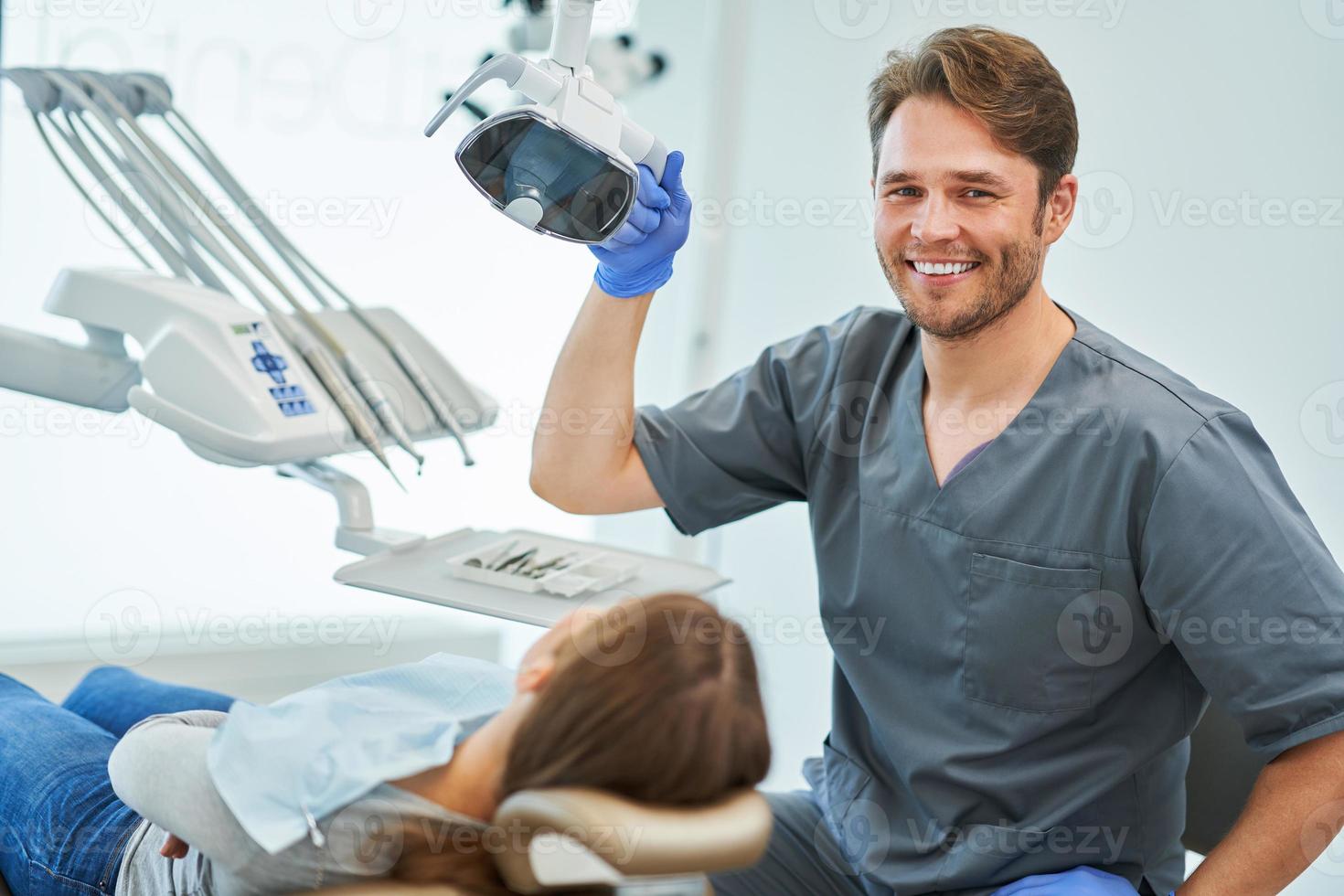 Male dentist and woman in dentist office photo