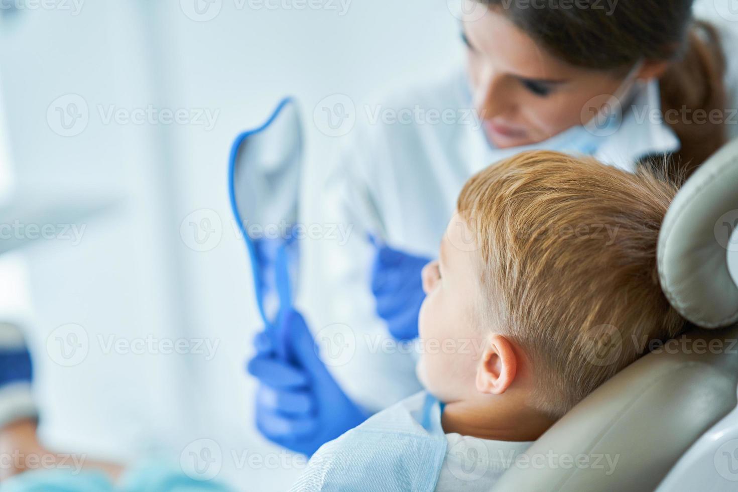 Little boy and female dentist in the dentists office photo