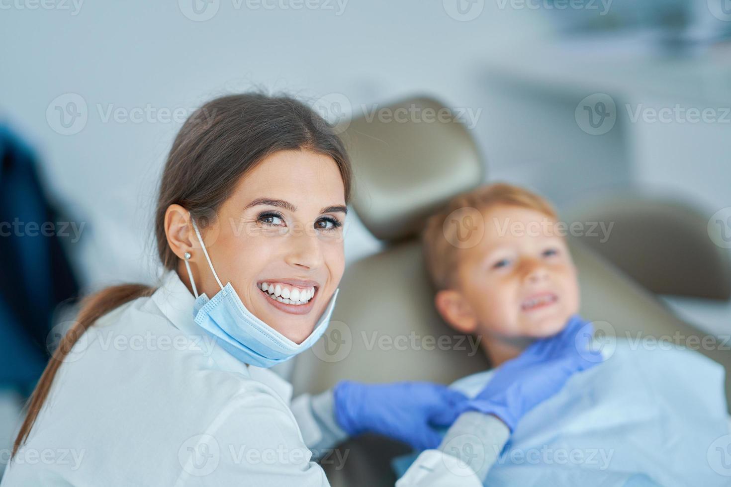 Little boy and female dentist in the dentists office photo