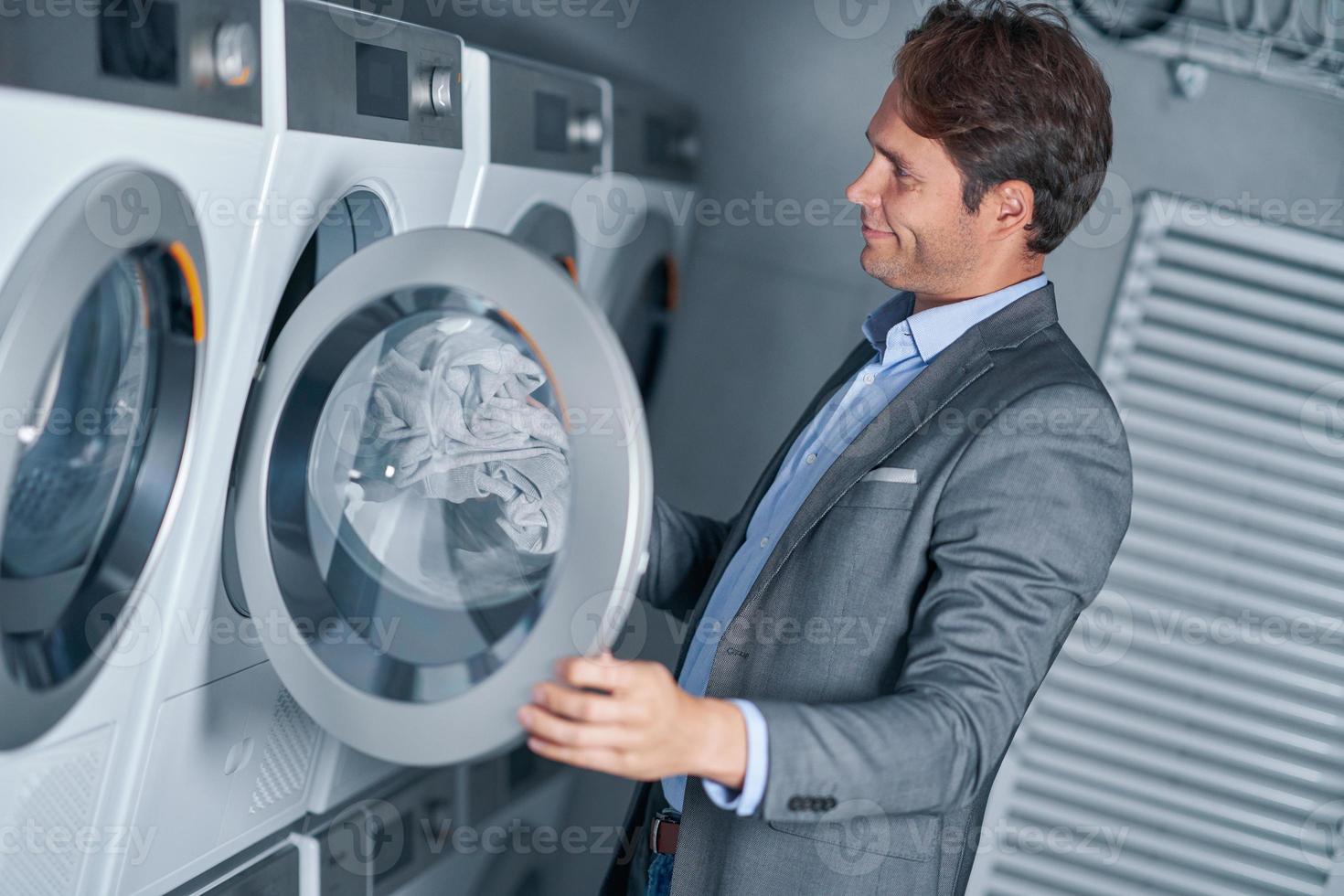 Young businessman in laundry room photo