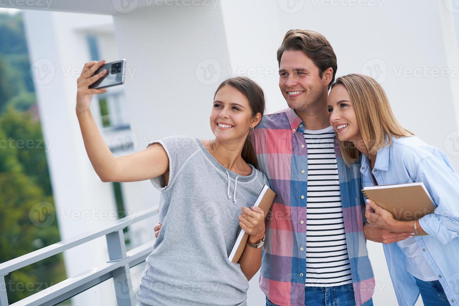 Group of students using smartphone in the campus photo