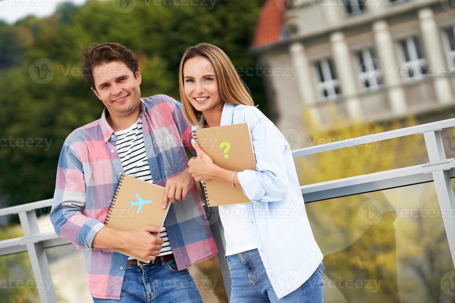 Couple of students standing together in the campus photo