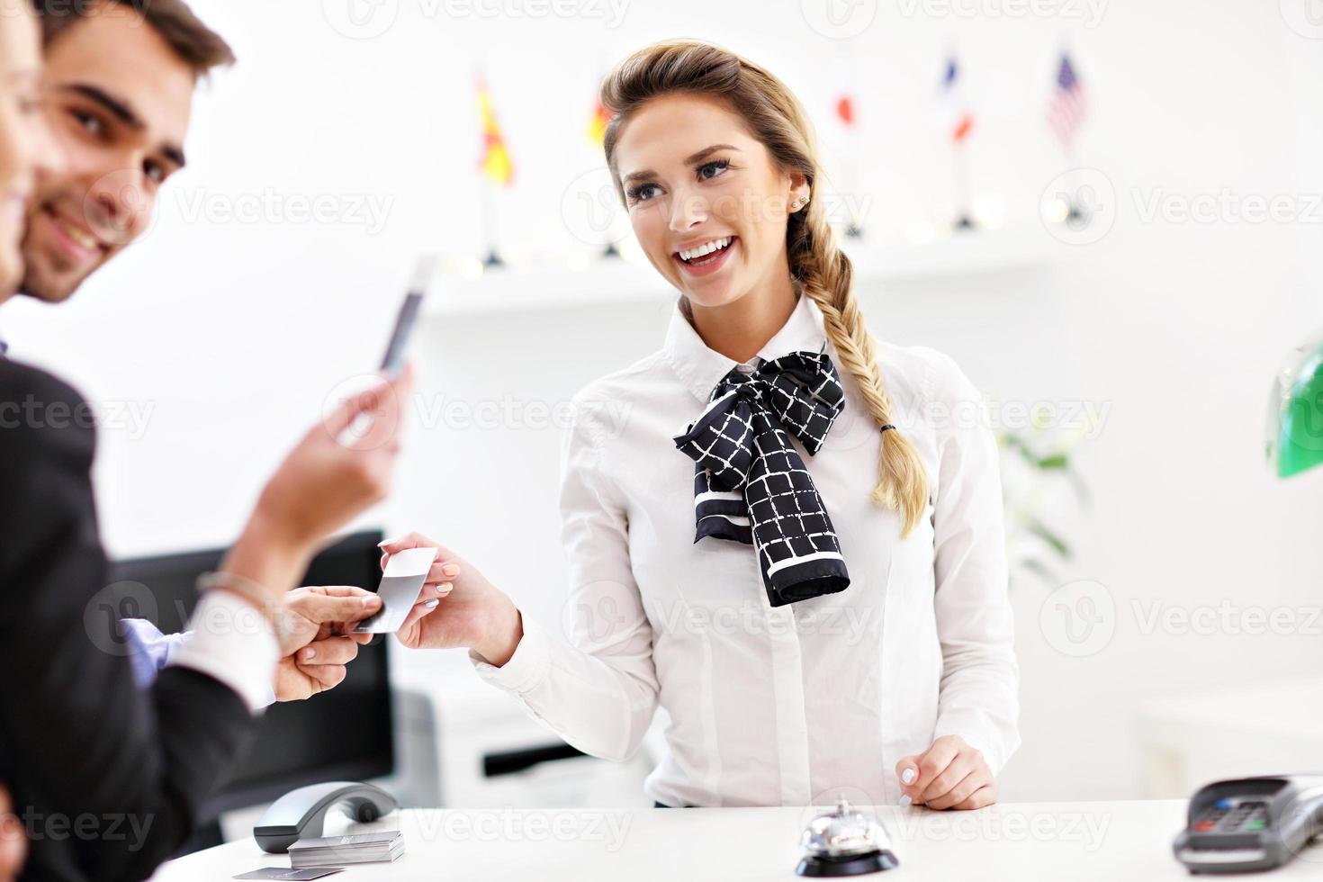 People paying in hotel reception photo