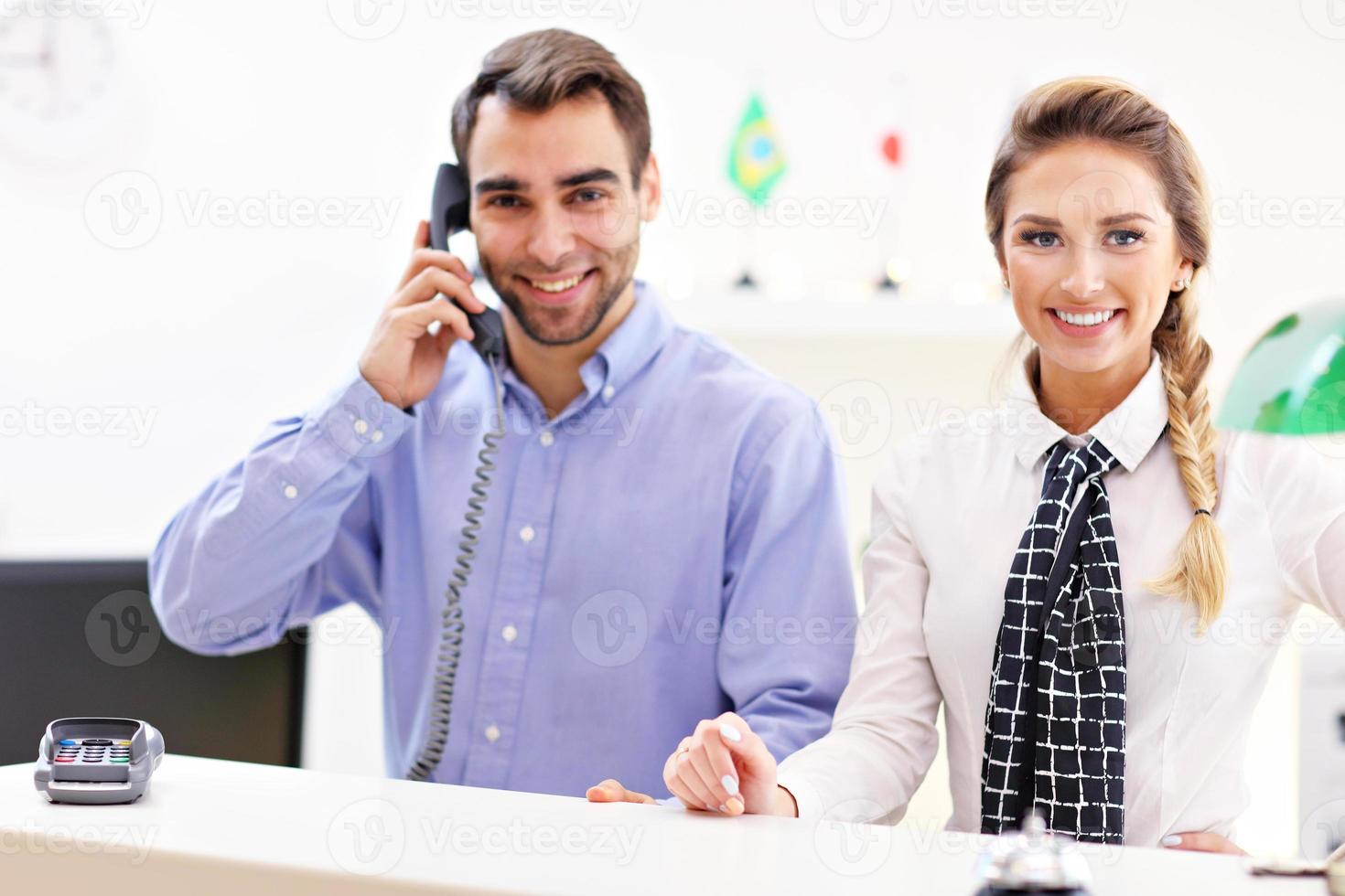 Happy team of hotel receptionists photo