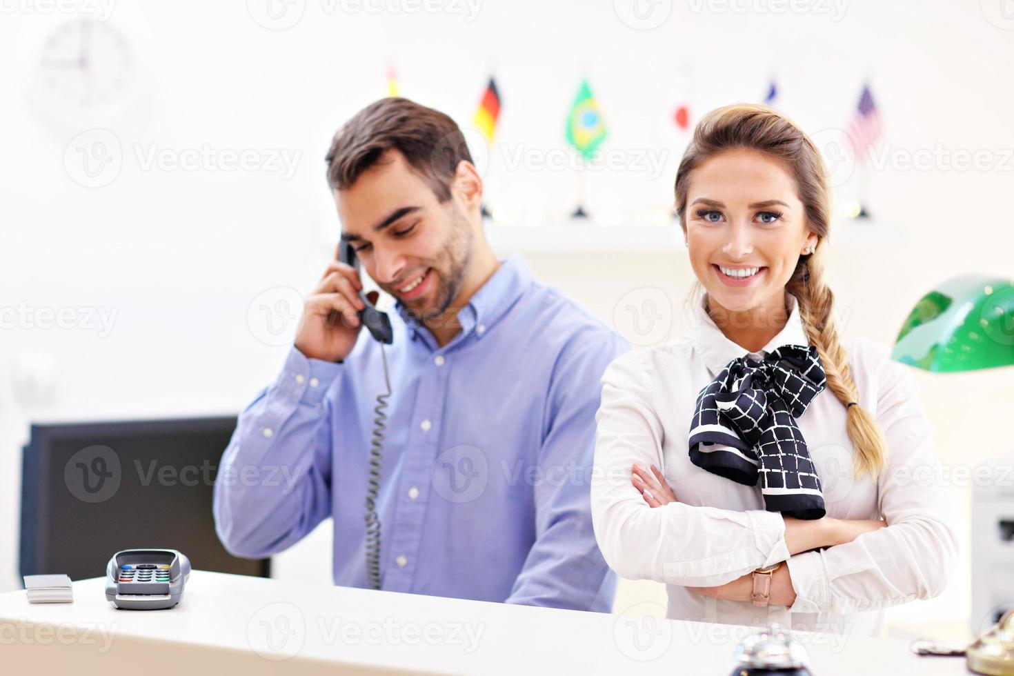 Happy team of hotel receptionists photo