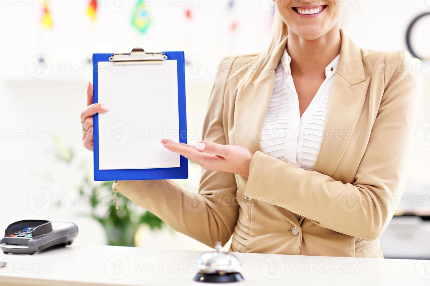 Happy receptionist working in hotel photo