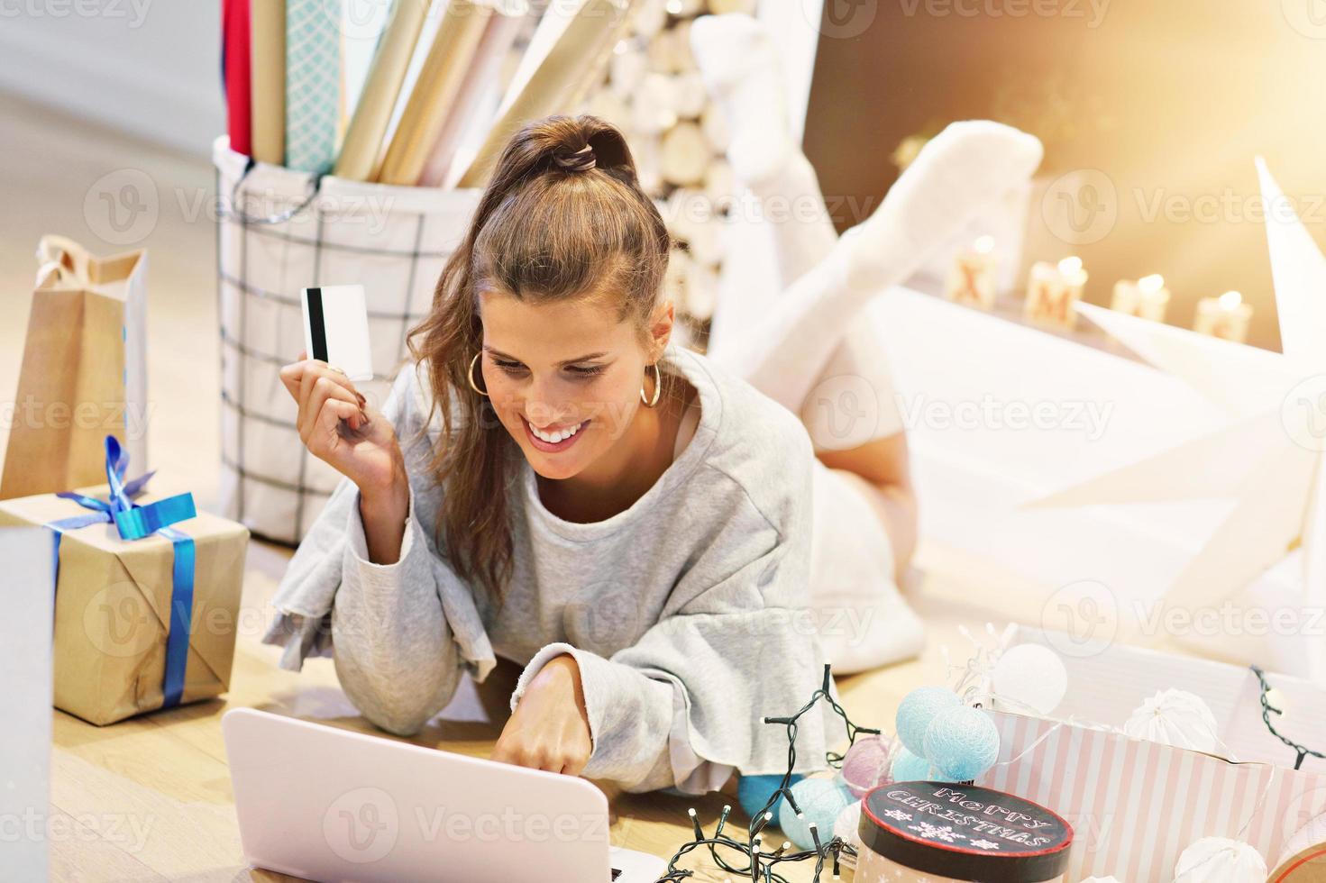 Adult woman at home wrapping Christmas presents photo