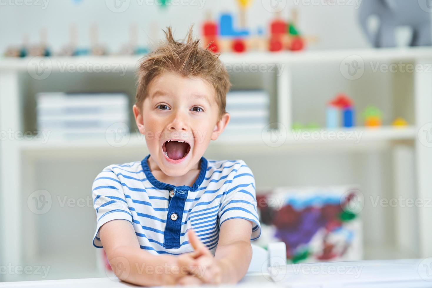 Adorable little boy in kindergarten photo