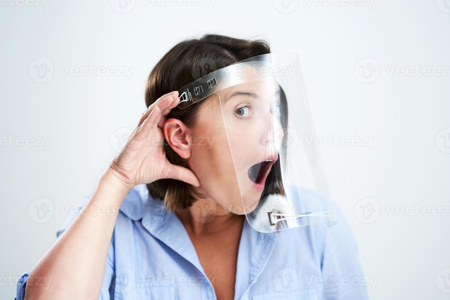 Attractive woman wearing protective shield isolated over white background photo