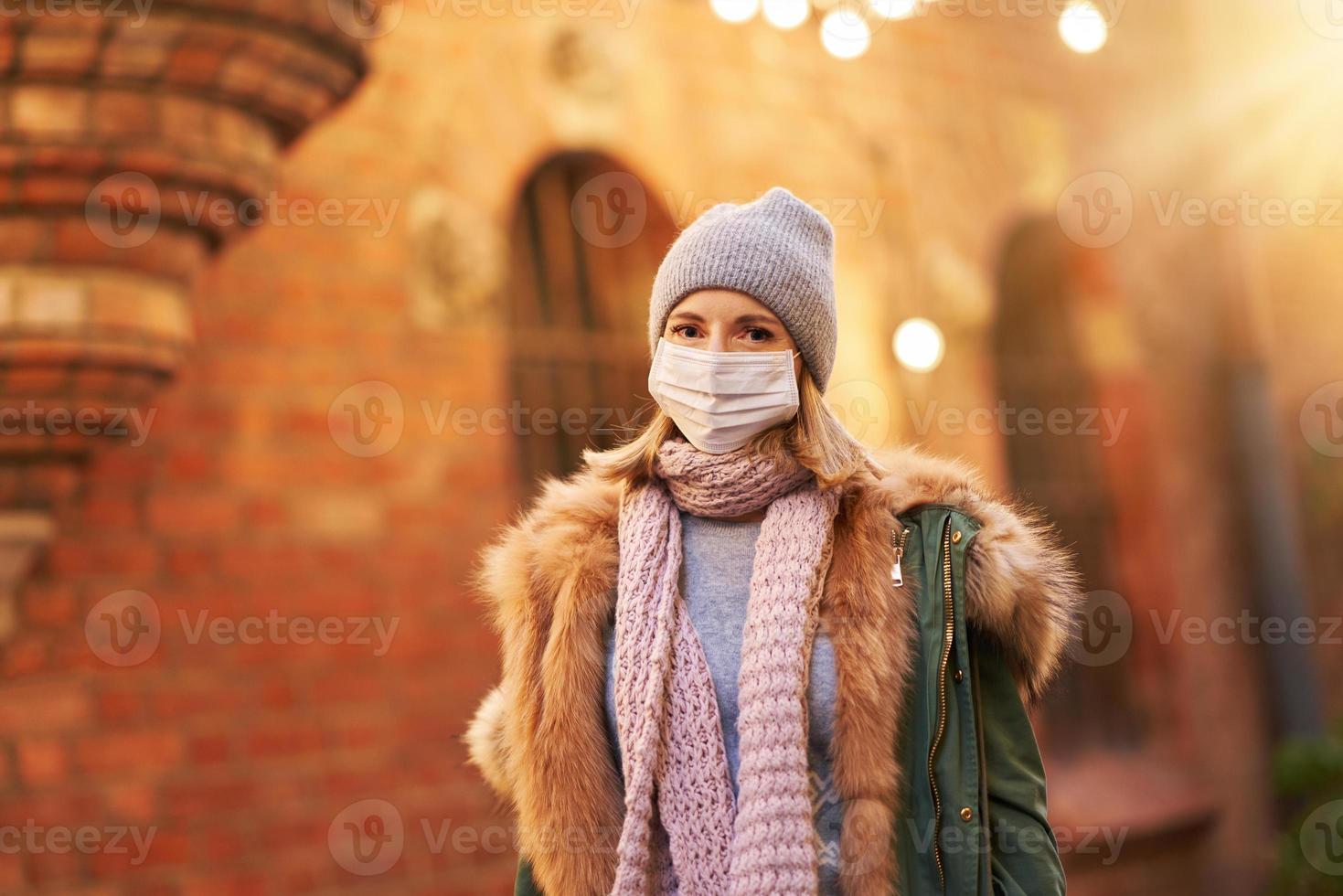 Woman wearing face mask because of Air pollution or virus epidemic in the city photo