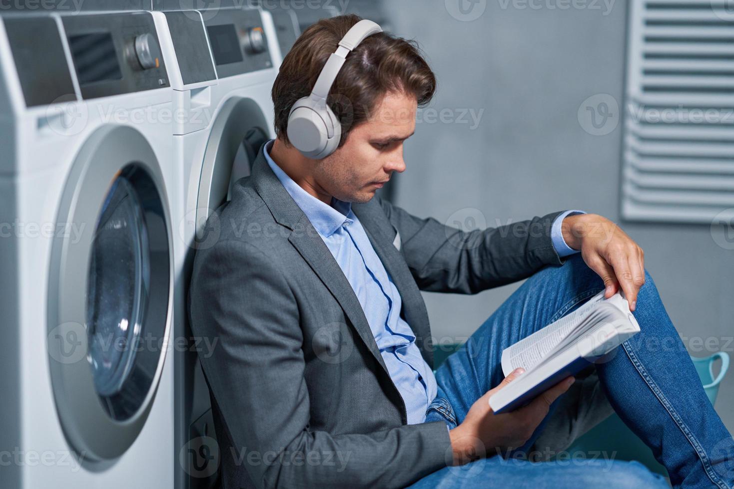 Young businessman in laundry room photo