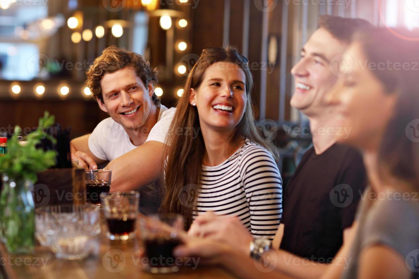 Group Of Friends Enjoying Meal In Restaurant photo