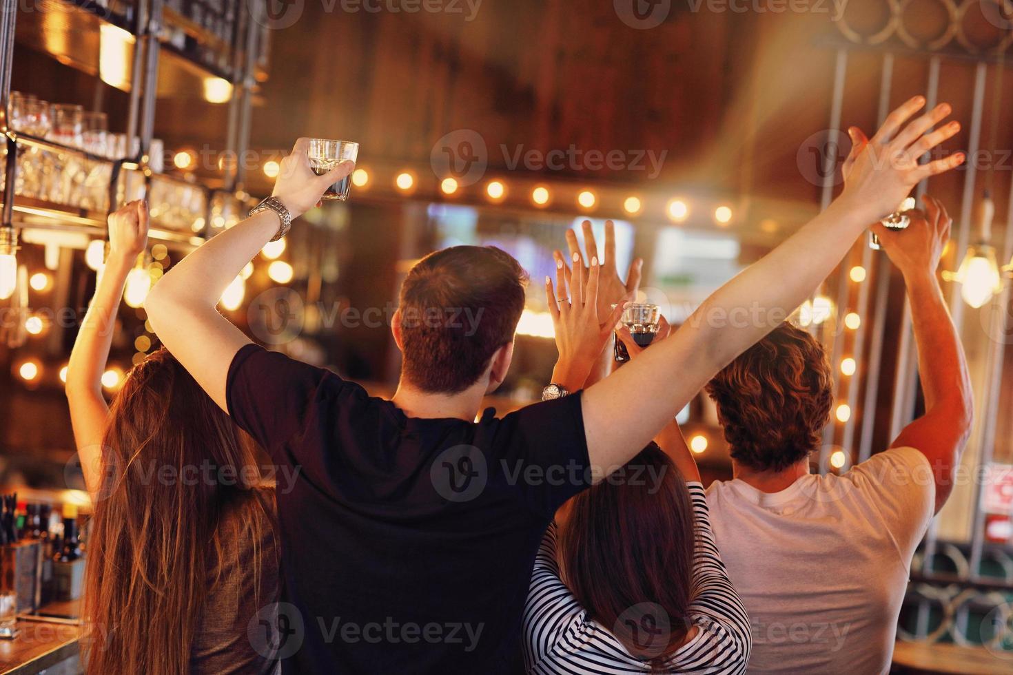 Group of friends watching soccer in pub photo