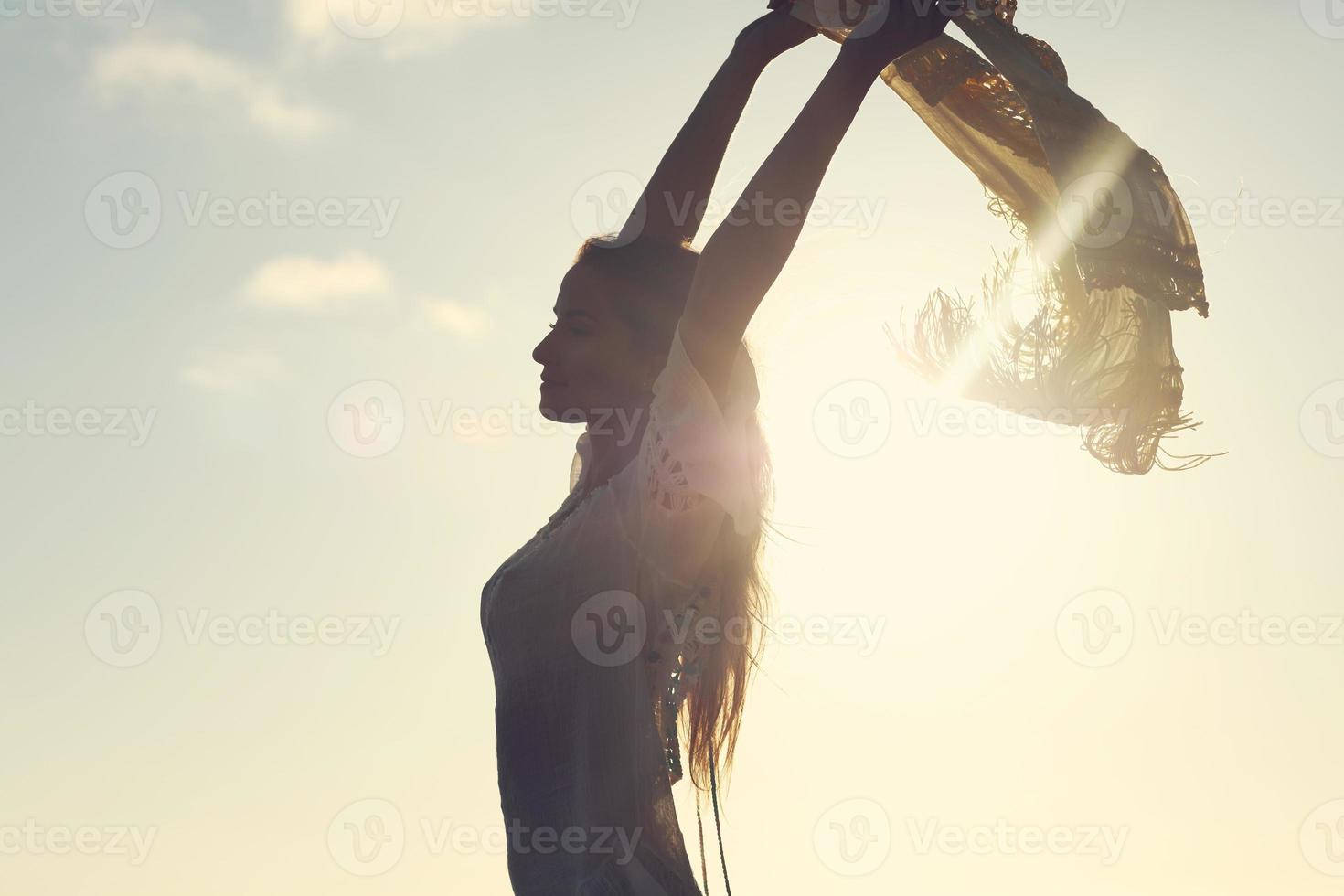 Beautiful sexy woman at dusk on the beach photo