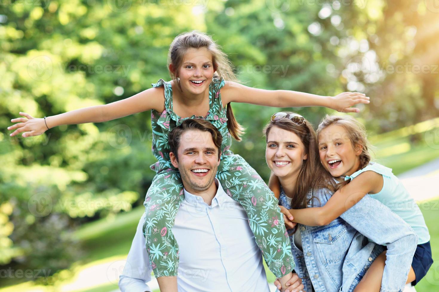 Young family with children having fun in nature photo