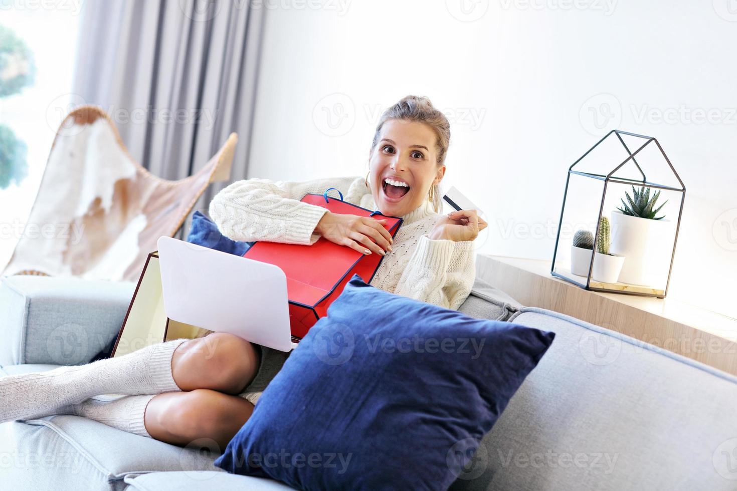 Adult woman wearing warm sweater and shoping online photo