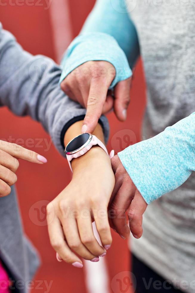 Man and woman racing on outdoor track photo