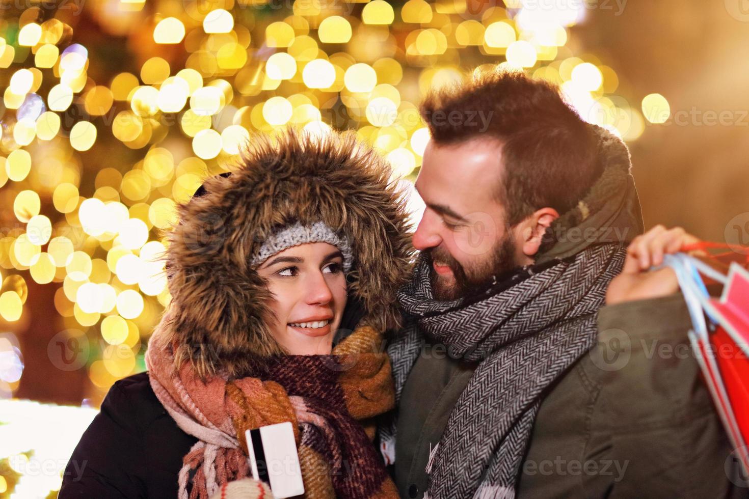 Adult couple shopping in the city during Christmas time photo