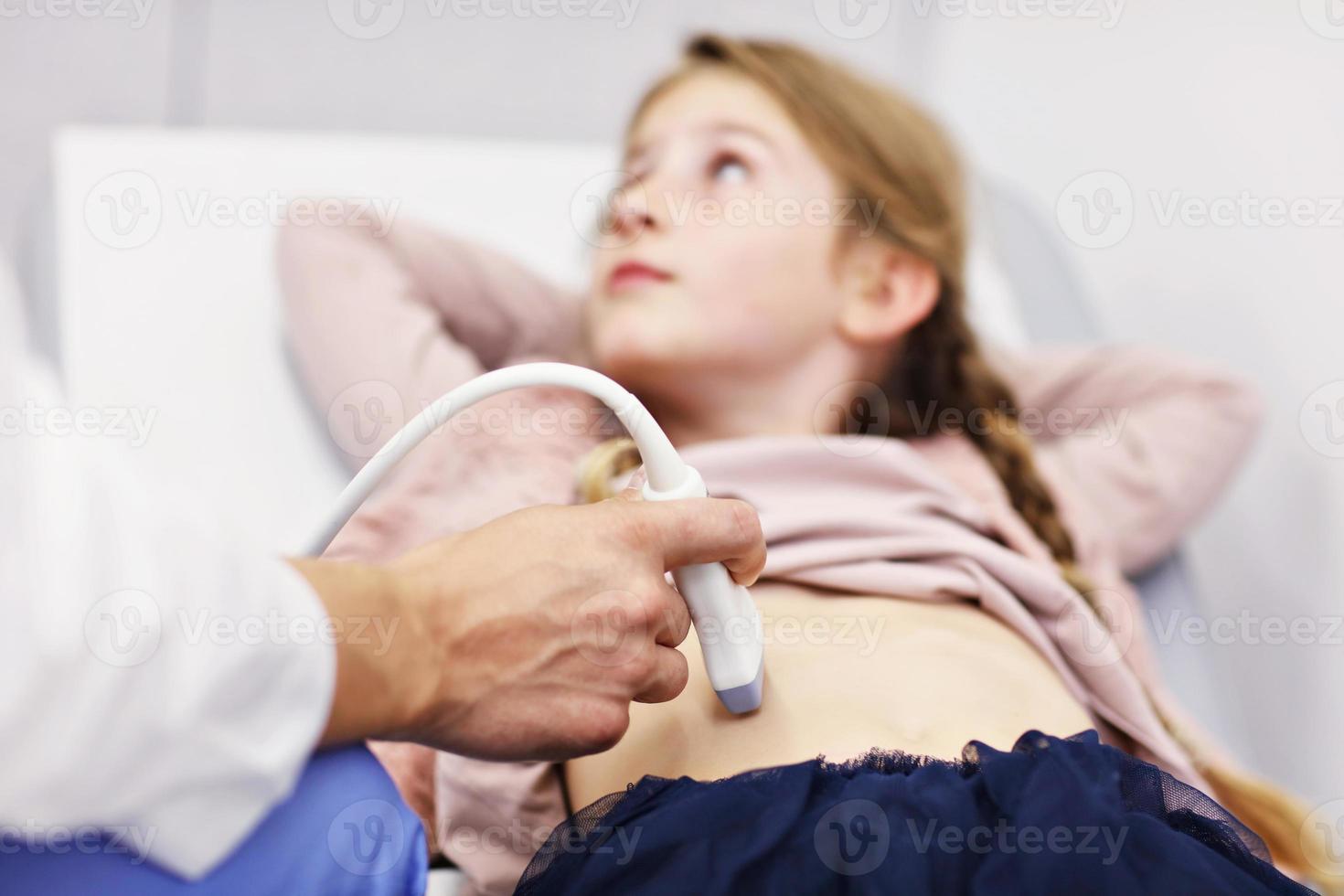 Doctor testing young girl with usg photo