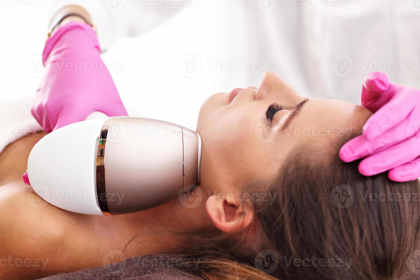 Adult woman having laser hair removal in professional beauty salon photo