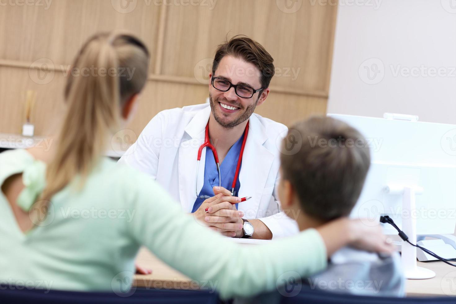 Little boy with mother in clinic having a checkup with pediatrician photo