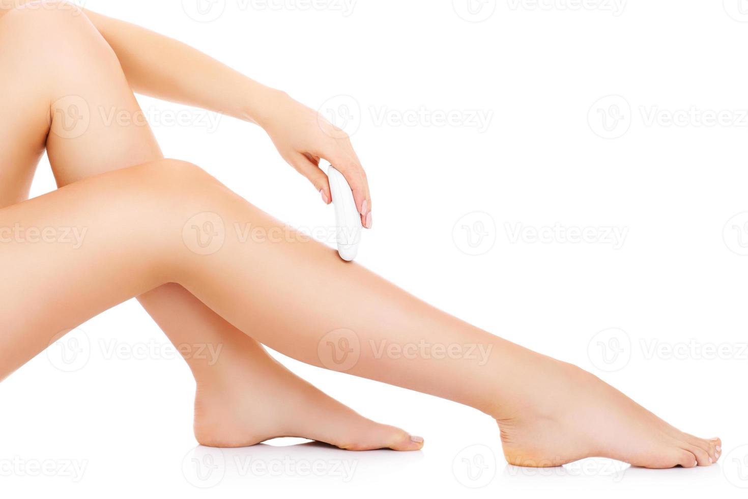 Leg depilation on white background photo