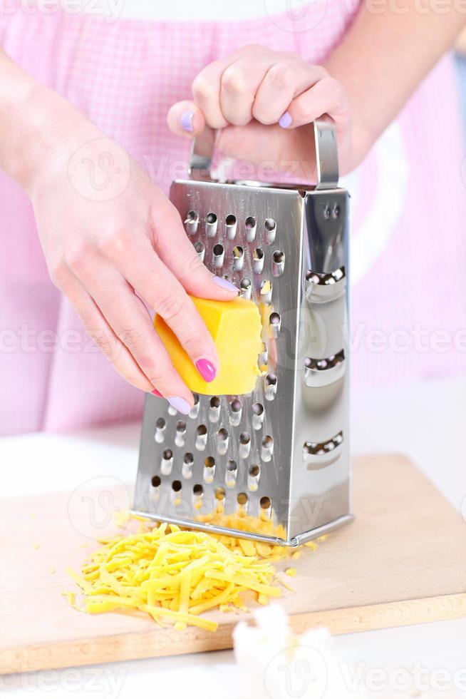 Grating cheese close-up photo