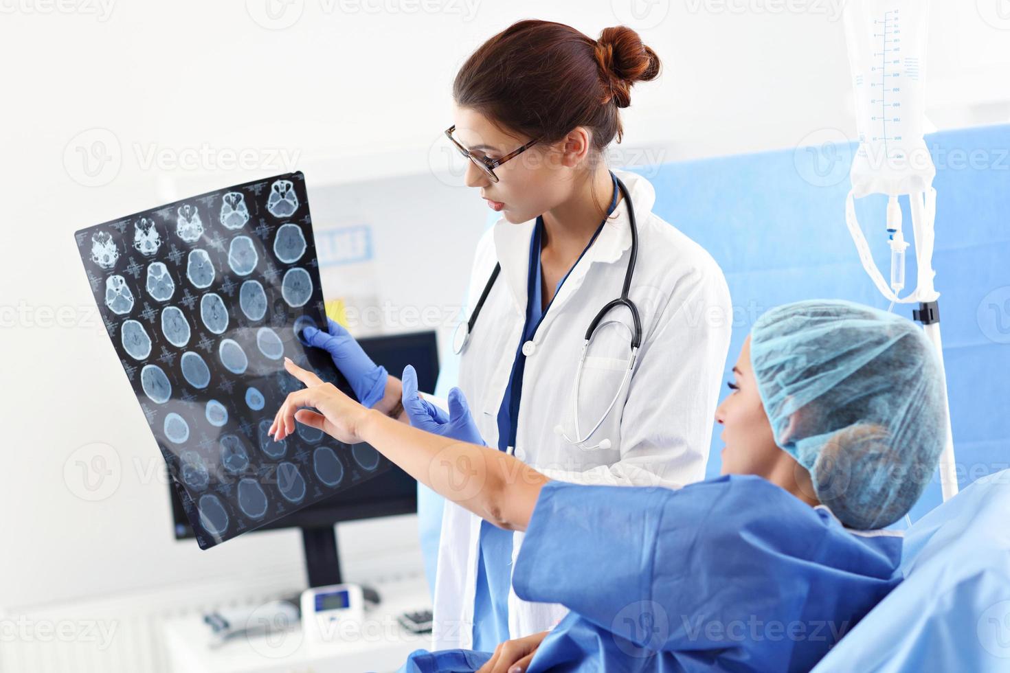 Female doctor taking care of patient in hospital photo