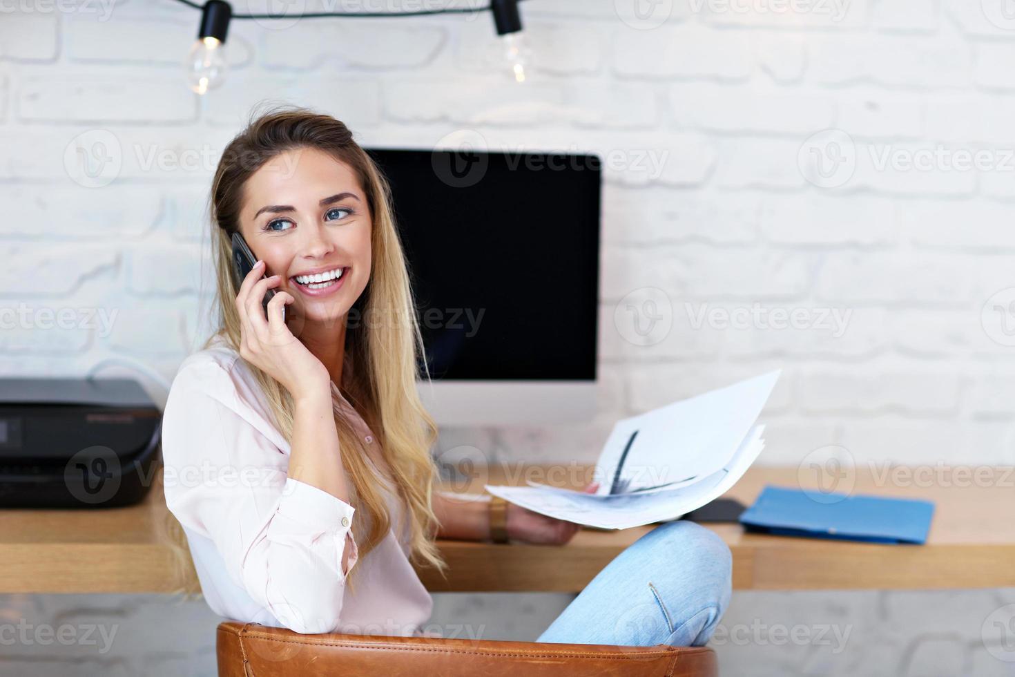 Portrait of beautiful millennial woman working in modern home office photo