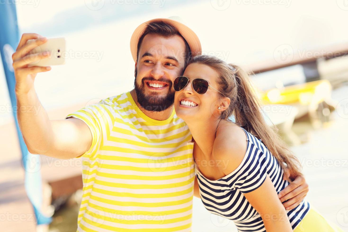 Happy couple having fun outdoors in summer photo