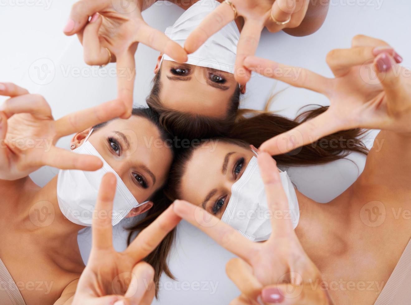 Diverse group of women in masks isolated over background photo