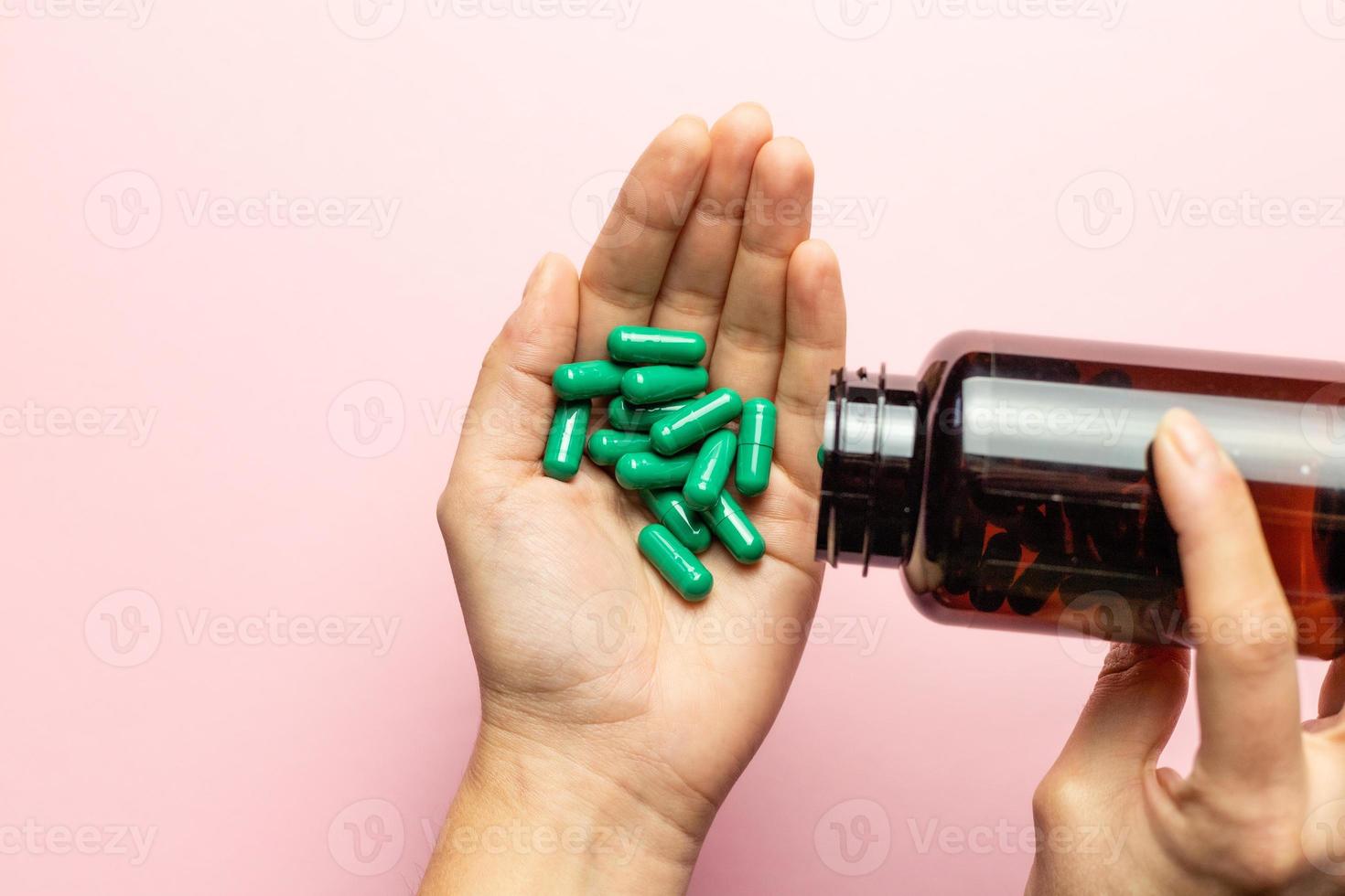 Rhodiola rosea capsules poured on the hand from the package. photo