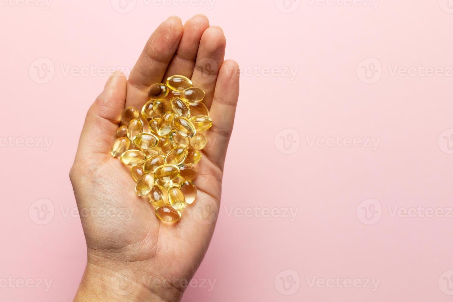 D3 K2 capsules on the hands. Strengthening immunity and care for health. photo