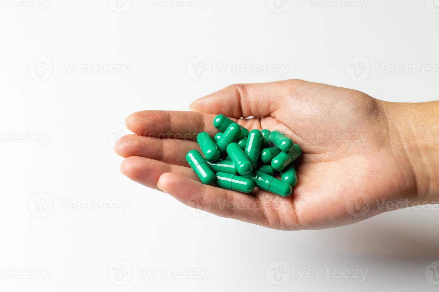 Rhodiola rosea capsules on a female hand. photo