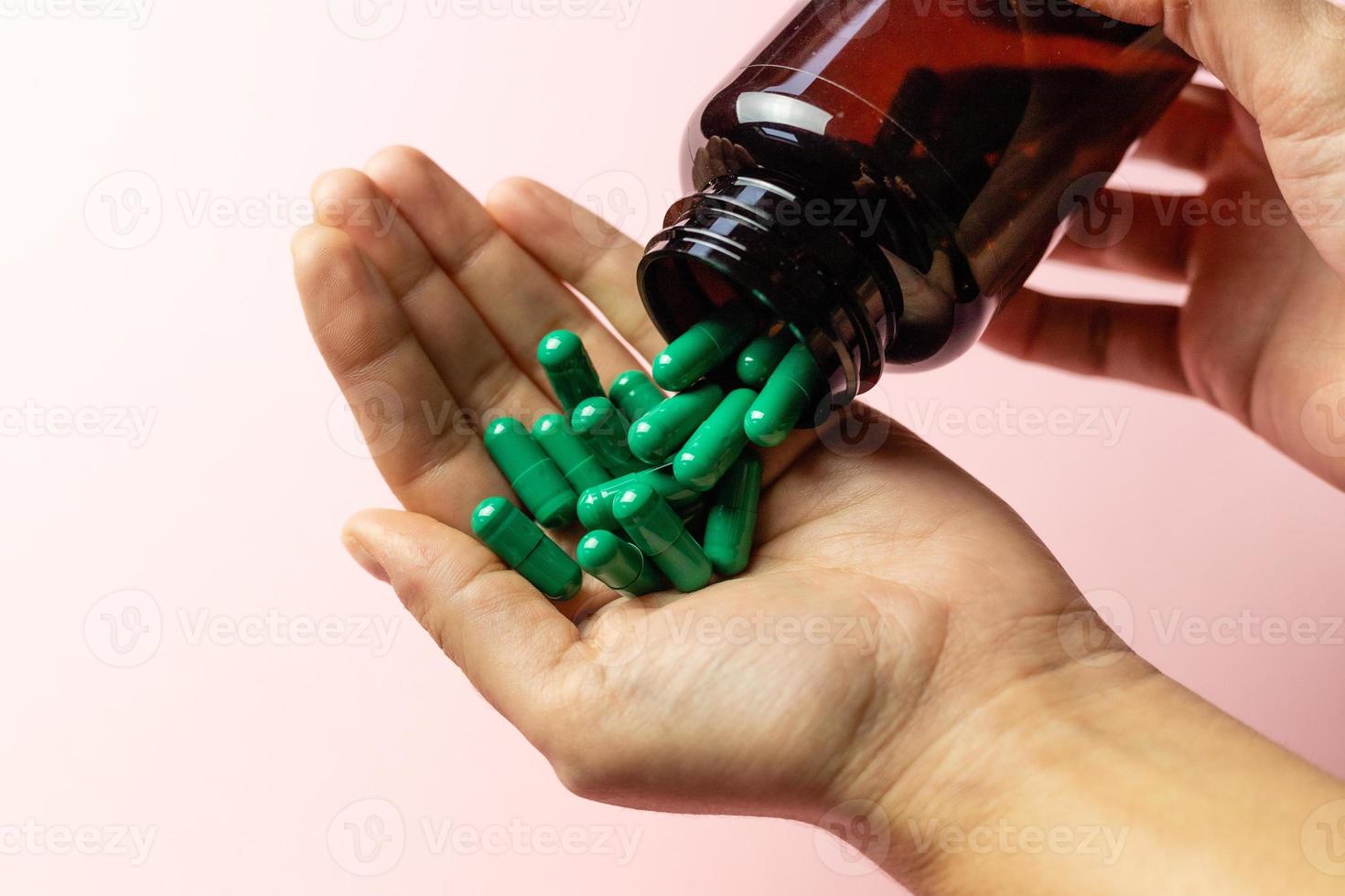Rhodiola rosea capsules poured on the hand from the package. photo