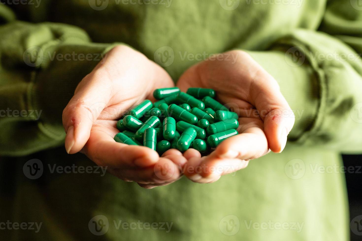 Caffeine capsules on woman's hands. The concept of arousal and energy. photo
