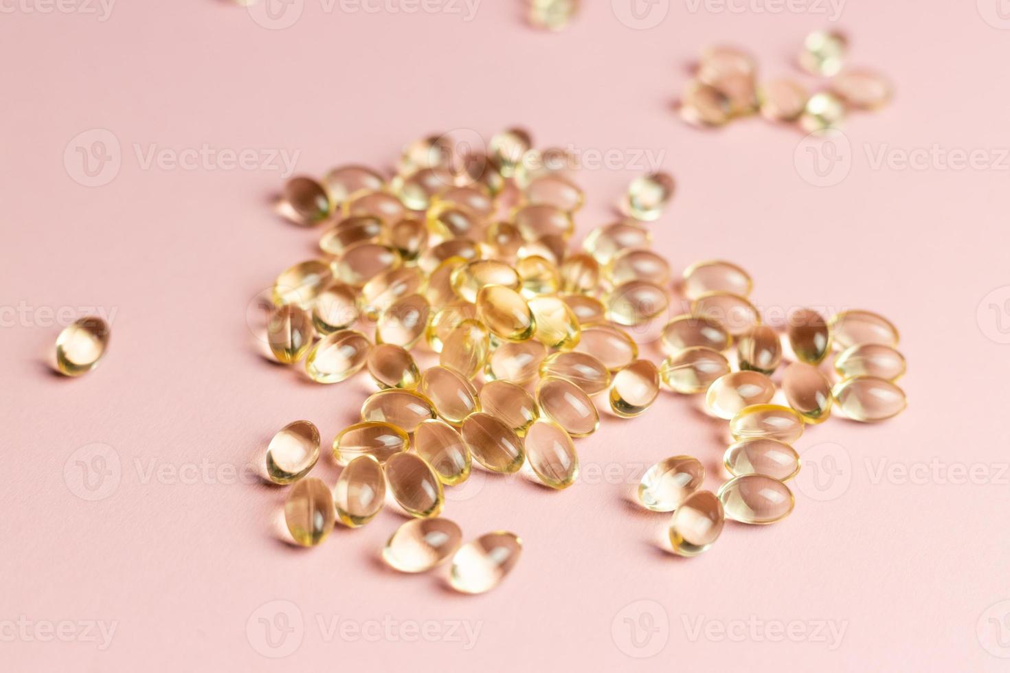 D3 K2 capsules on a pink background. Healthy life concept. photo
