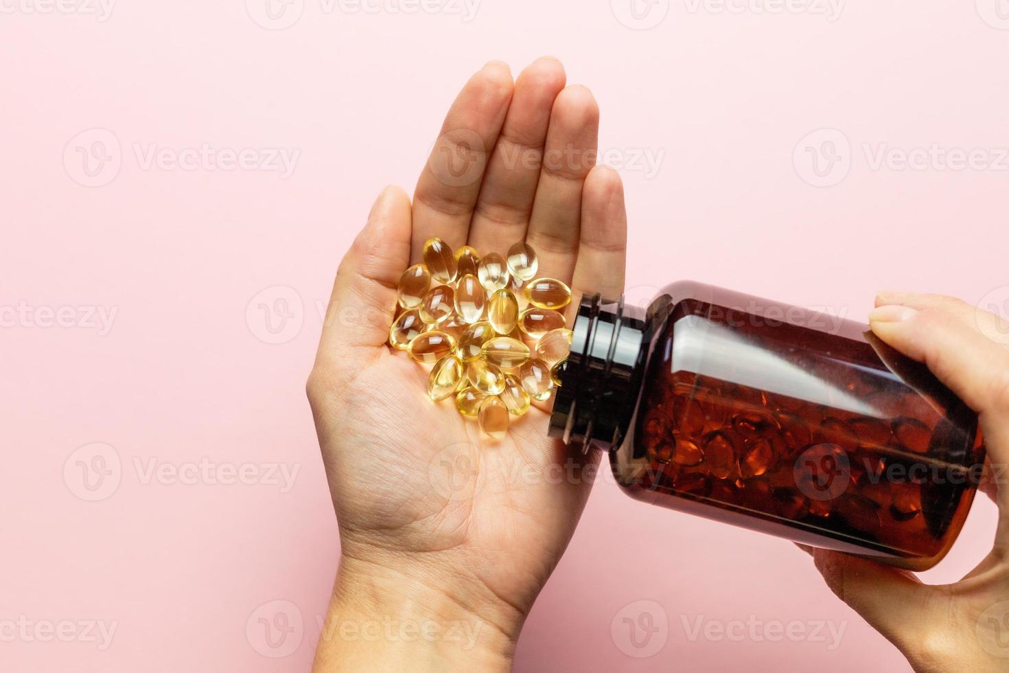 Vitamin D3 capsules poured out of the package. Care for health and immunity. A woman's hand. photo