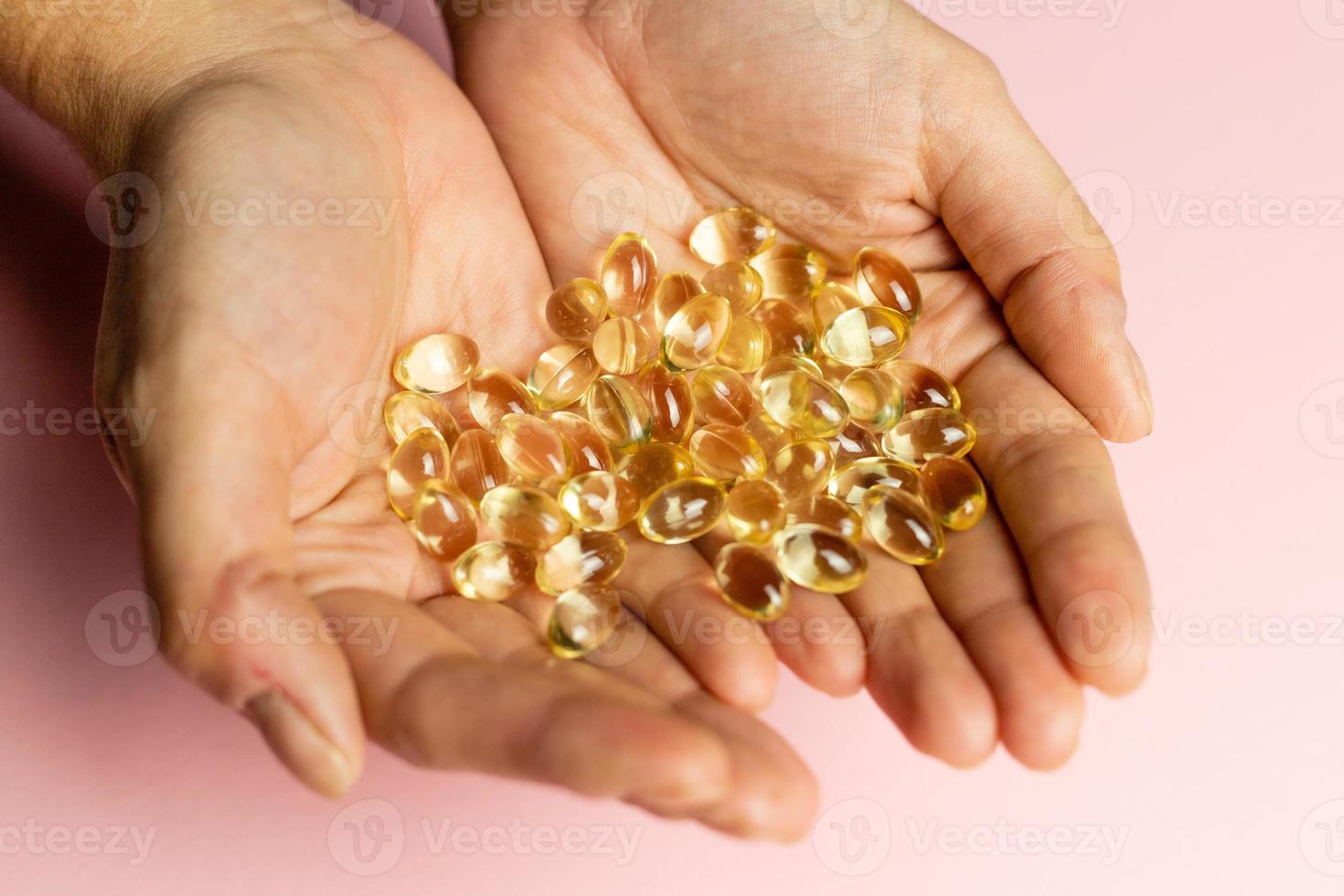 D3 K2 capsules on the hands. Strengthening immunity and care for health. photo