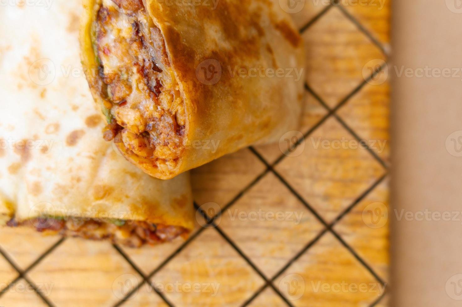 Pastor mexican burrito with meat and hot sauce photo