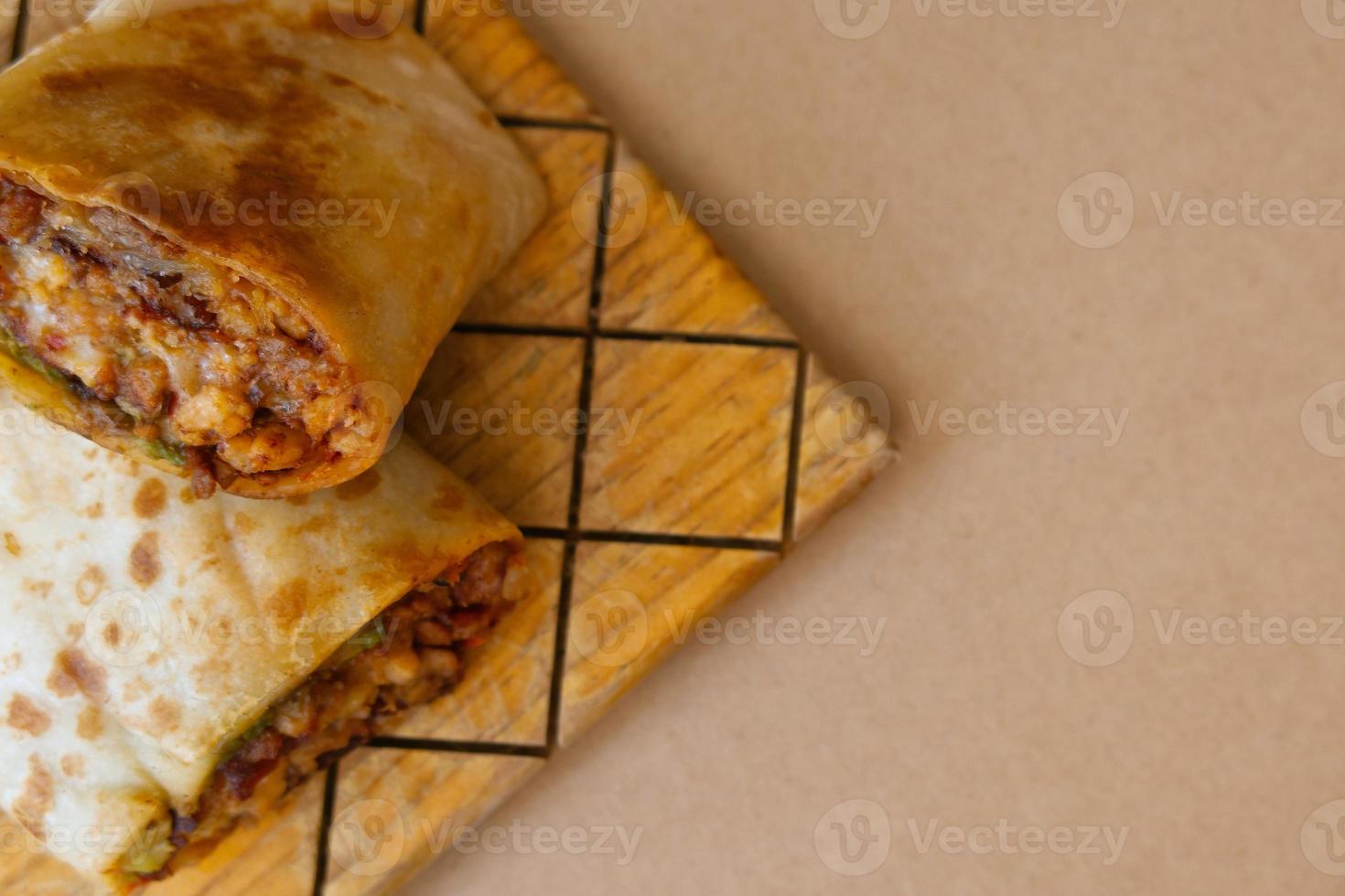 Pastor mexican burrito with meat and hot sauce photo