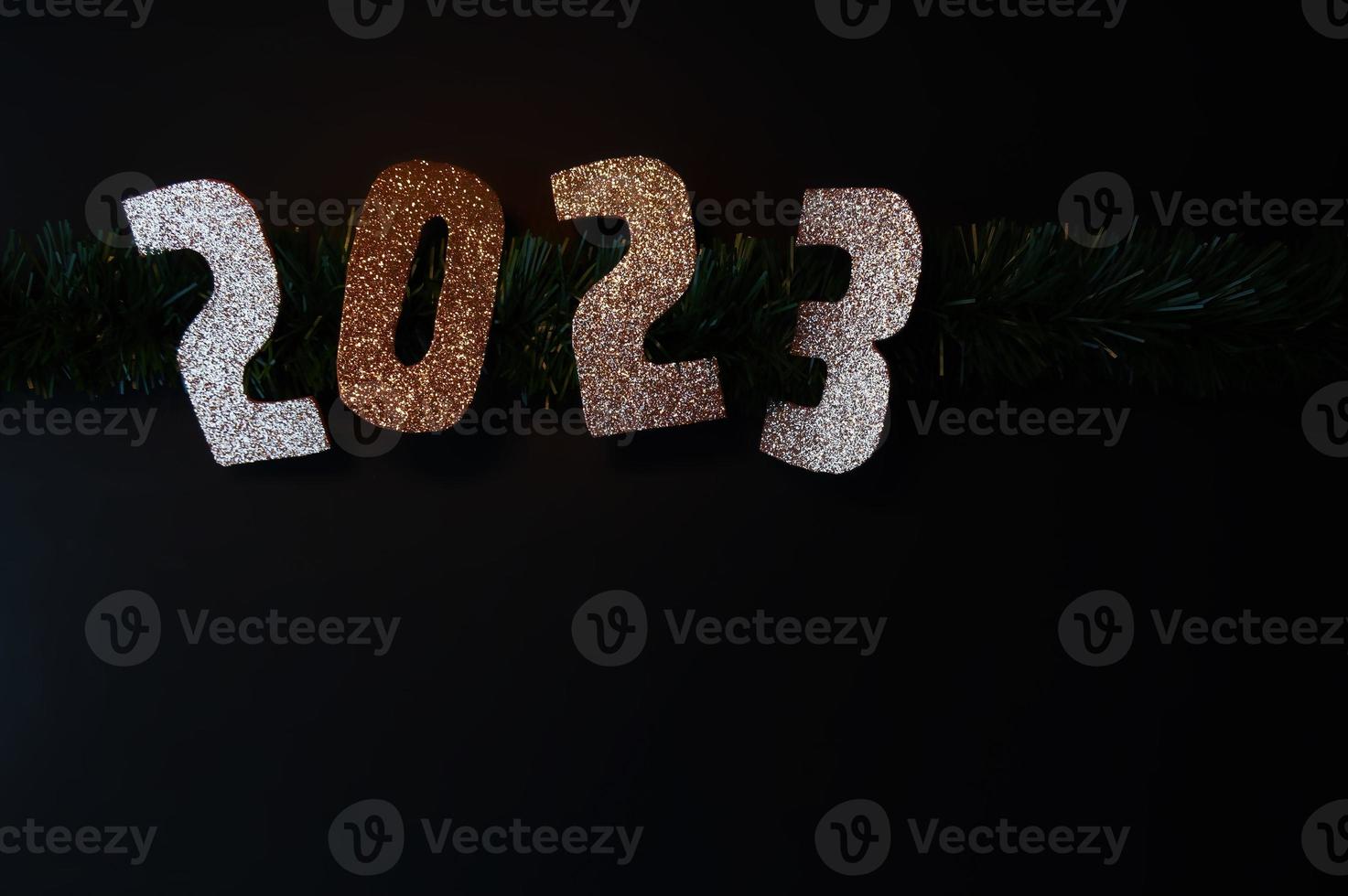 Happy New Year 2023. Golden numbers on a black background with glitter photo
