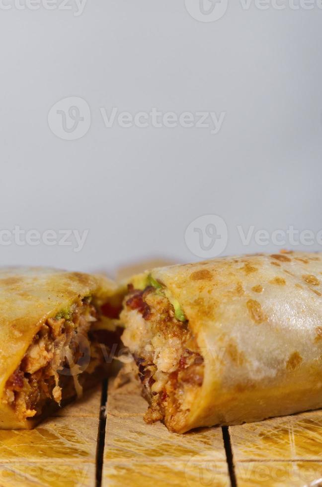 Pastor mexican burrito with meat and hot sauce photo