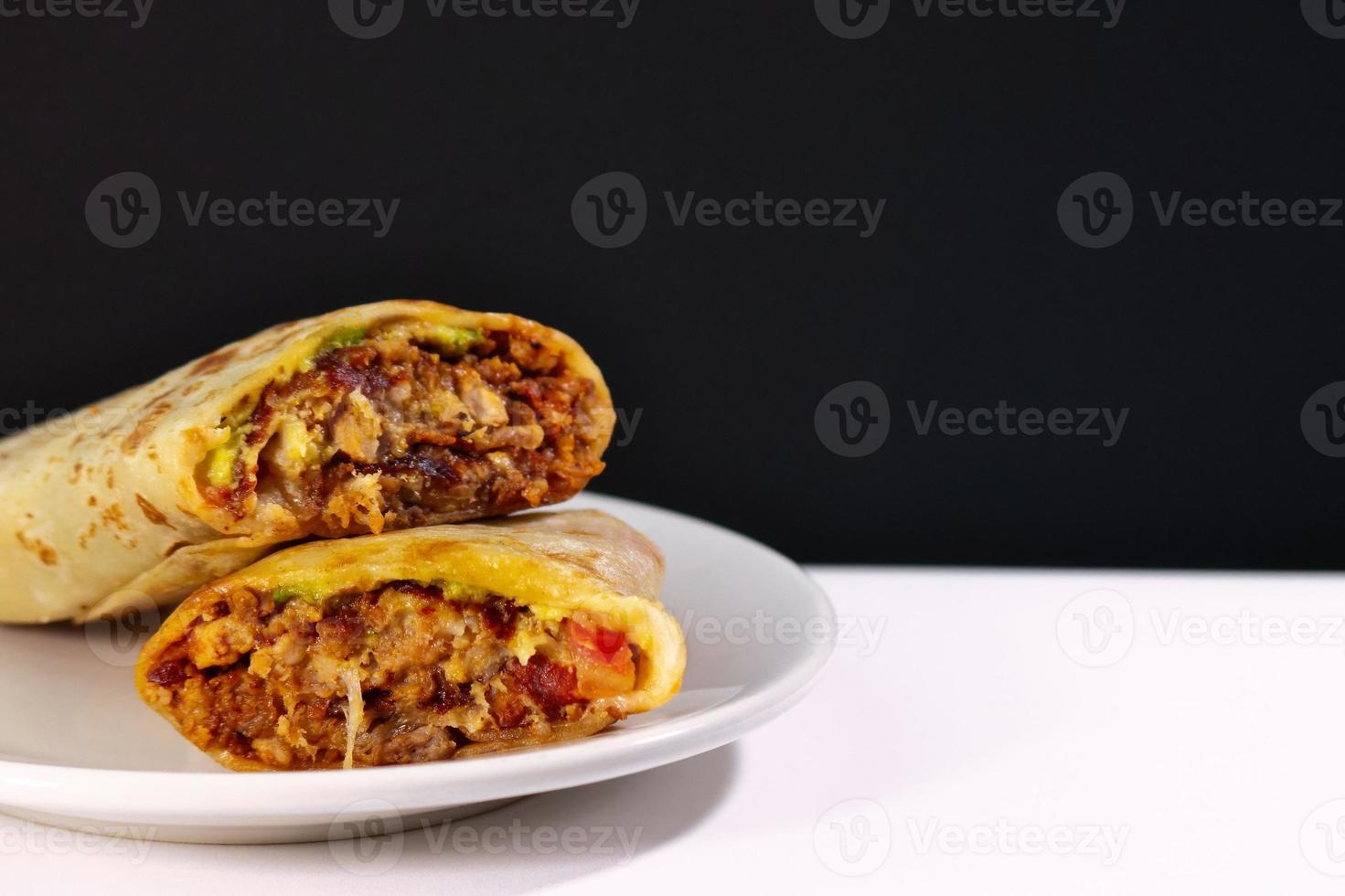 Pastor mexican burrito with meat and hot sauce photo