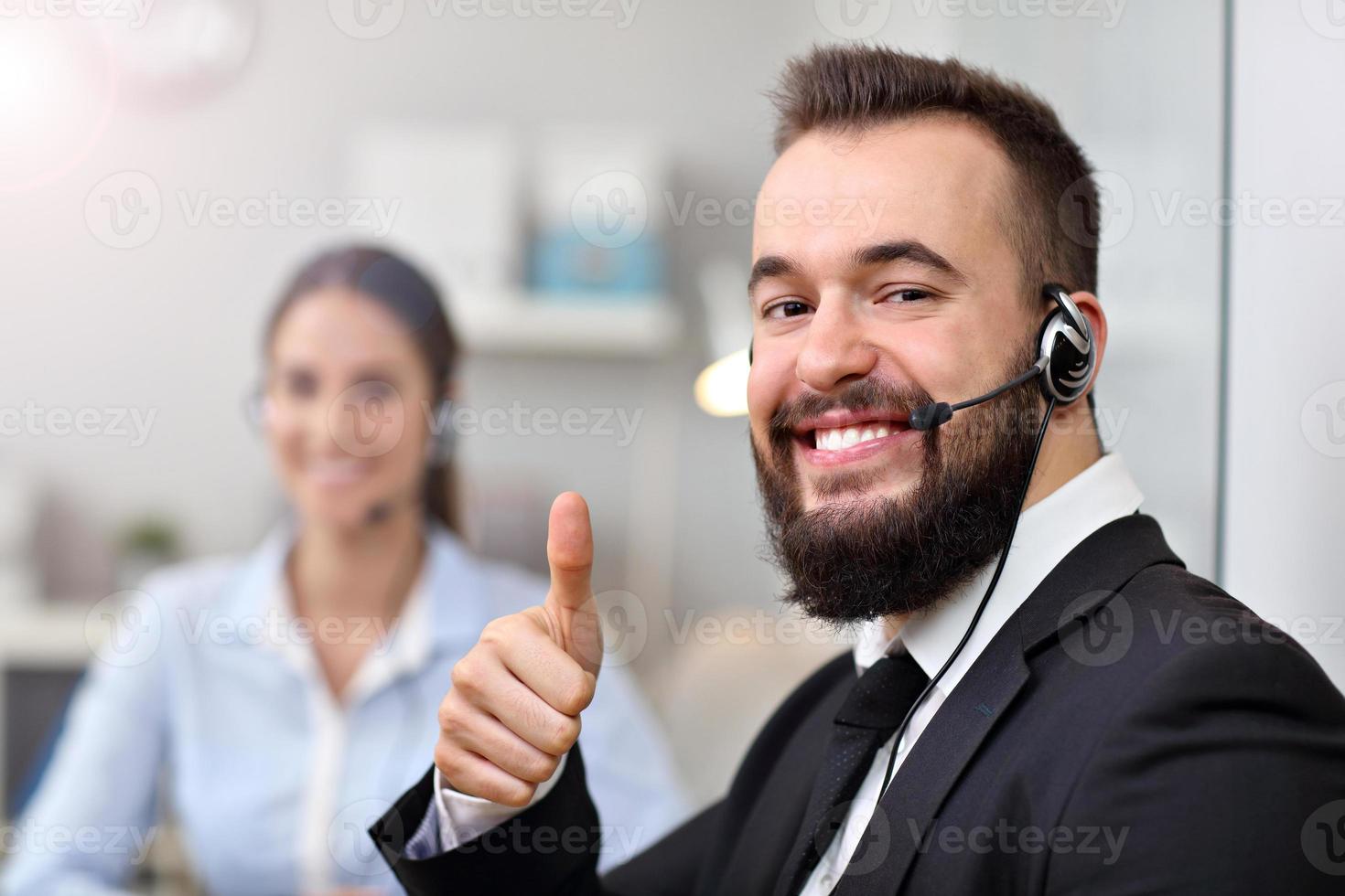 Happy man in call center photo