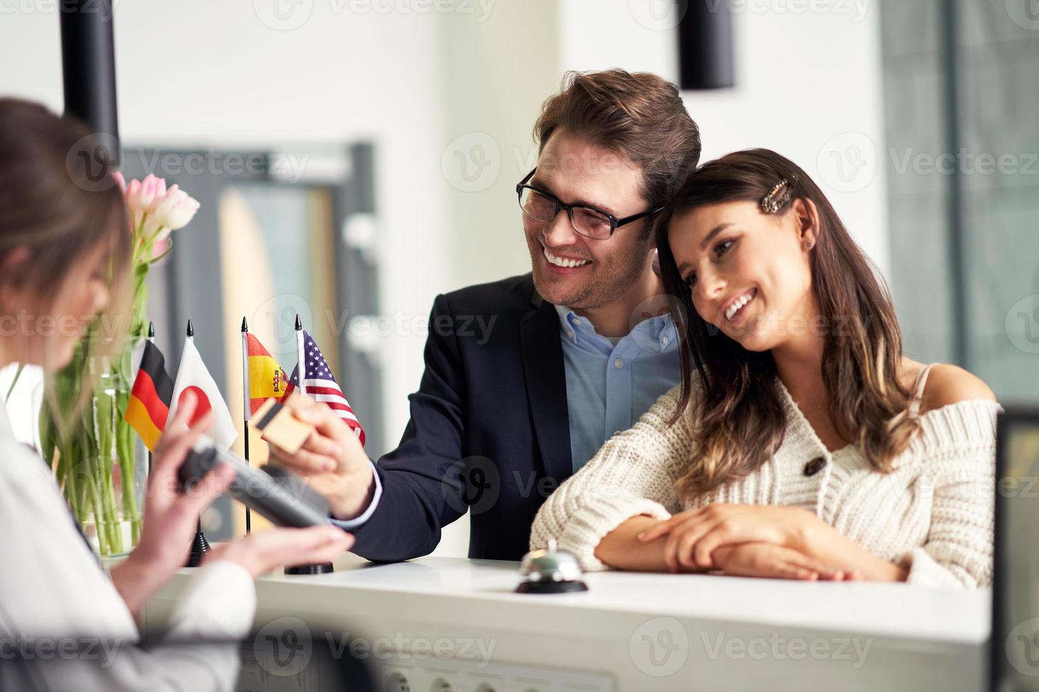 Adult couple checking-in a hotel photo