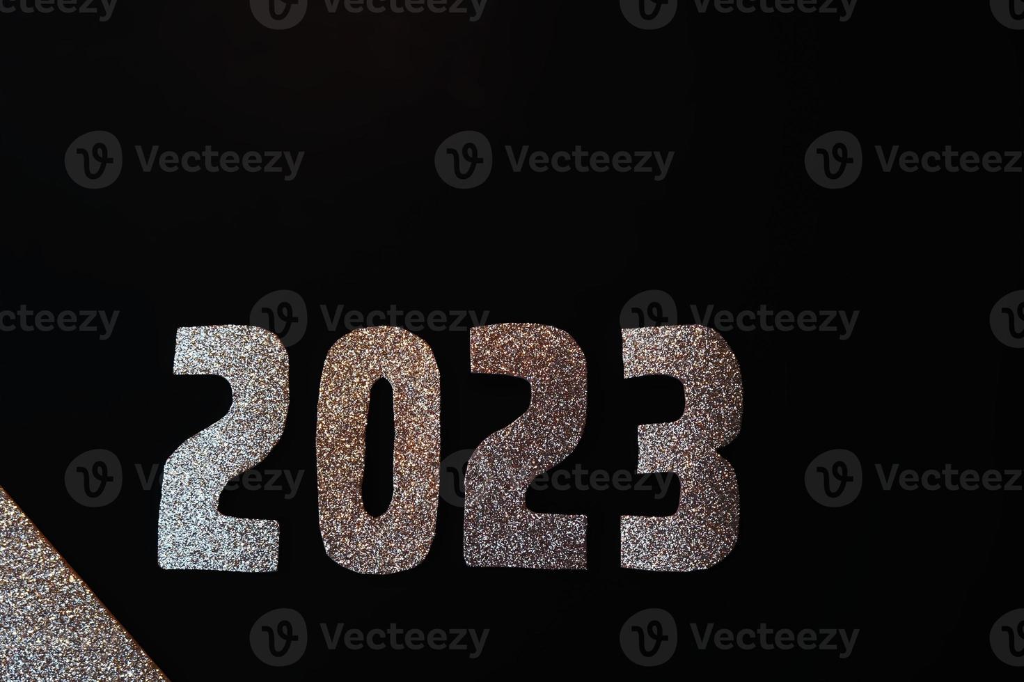 Happy New Year 2023. Golden numbers on a black background with glitter photo
