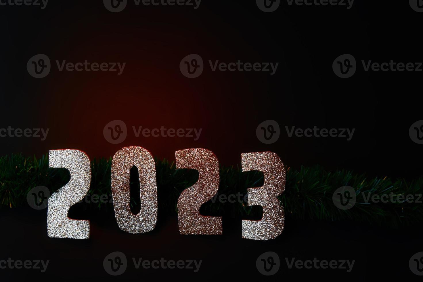 Happy New Year 2023. Golden numbers on a black background with glitter photo